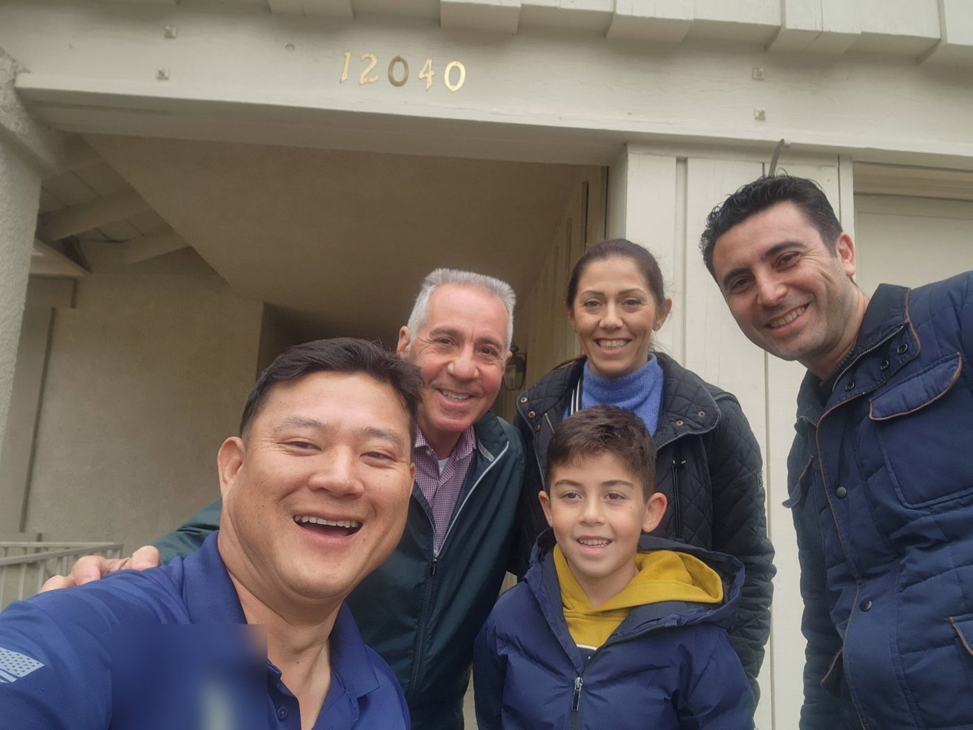 Happy homeowners at their front door